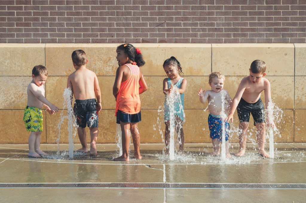 Kids Playing in Water Fountain